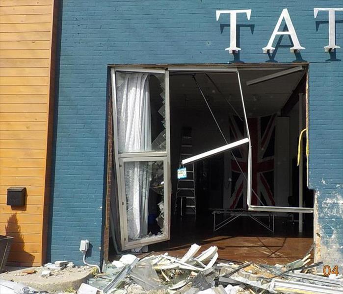 Completely destroyed doorway into a business.